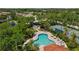 Aerial shot of a pool, tennis court, and gazebo in a desirable neighborhood at 6617 Cheswick St, Sarasota, FL 34243