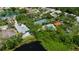 Great location in the community, aerial view of the home near the pool, tennis court, and lake at 6617 Cheswick St, Sarasota, FL 34243