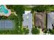 A beautiful aerial view of a home featuring a pool and tennis court in a desirable neighborhood at 6617 Cheswick St, Sarasota, FL 34243