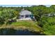 Aerial view of the home featuring a backyard patio with pond views at 6617 Cheswick St, Sarasota, FL 34243