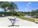 A hammock and seating area are located on a patio overlooking a beautiful lake at 6617 Cheswick St, Sarasota, FL 34243
