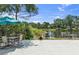 Outdoor seating area features a beautiful view of the pond and surrounding trees at 6617 Cheswick St, Sarasota, FL 34243
