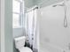 Bathroom featuring a tile tub, shower, and toilet at 6617 Cheswick St, Sarasota, FL 34243