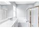 Bright bathroom featuring a double sink vanity, soaking tub, and glass-enclosed shower at 6617 Cheswick St, Sarasota, FL 34243