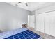 Spacious bedroom with blue accents, carpet flooring, a window and closet doors at 6617 Cheswick St, Sarasota, FL 34243