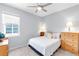 Cozy bedroom with neutral walls, carpet flooring, and a window providing natural light at 6617 Cheswick St, Sarasota, FL 34243