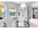 Cozy breakfast nook with natural light, glass table, backyard views, and easy access to the outdoor patio at 6617 Cheswick St, Sarasota, FL 34243