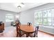 Bright dining room features hardwood floors and large windows at 6617 Cheswick St, Sarasota, FL 34243