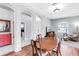 Bright dining room features hardwood floors, tray ceilings, and large windows at 6617 Cheswick St, Sarasota, FL 34243