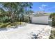 Inviting single-story home showcases a wide driveway, two-car garage, and manicured front yard, perfect for suburban living at 6617 Cheswick St, Sarasota, FL 34243