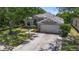 Charming single-Gathering home with a manicured lawn, mature trees, and a two-car garage at 6617 Cheswick St, Sarasota, FL 34243