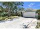 Charming single-story home features a manicured lawn, gray exterior, and a white garage door at 6617 Cheswick St, Sarasota, FL 34243
