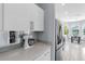 Modern kitchen with sleek white cabinets, stainless steel appliances, and breakfast nook, perfect for gatherings at 6617 Cheswick St, Sarasota, FL 34243