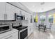 Bright kitchen with stainless steel appliances, white cabinets, a breakfast nook, and lots of natural light at 6617 Cheswick St, Sarasota, FL 34243