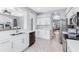 Contemporary kitchen featuring stainless steel appliances, a modern sink, white cabinets, and an open design at 6617 Cheswick St, Sarasota, FL 34243