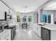 Stylish kitchen showcasing stainless steel appliances, white cabinets, and a view to the outdoor living space at 6617 Cheswick St, Sarasota, FL 34243