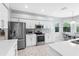Well-equipped kitchen with stainless steel appliances, white cabinets, granite countertops, and open layout design at 6617 Cheswick St, Sarasota, FL 34243