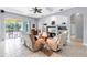 Open-concept living room with built-in shelving, tile flooring, and a sliding glass door to the backyard at 6617 Cheswick St, Sarasota, FL 34243