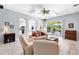 Comfortable living room with arched doorways, tile floors, and neutral tones at 6617 Cheswick St, Sarasota, FL 34243