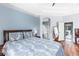 Serene main bedroom with blue accent wall, hardwood floors, and en-suite bathroom at 6617 Cheswick St, Sarasota, FL 34243