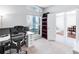 Bright home office featuring a white desk, ergonomic chair, and built-in shelving for optimal organization at 6617 Cheswick St, Sarasota, FL 34243