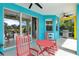 The patio features an outdoor kitchen and pond views through sliding glass doors at 6617 Cheswick St, Sarasota, FL 34243