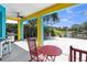 Outdoor patio with colorful accents, a grill, ceiling fan, and beautiful view of the lake at 6617 Cheswick St, Sarasota, FL 34243