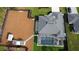 Aerial view of a new construction home featuring a pool, spacious backyard, and pristine landscaping at 6875 Beckwith Ave, North Port, FL 34291