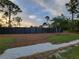Fenced yard with well-kept grounds and stone-lined border, providing a private and secure outdoor space at 6875 Beckwith Ave, North Port, FL 34291