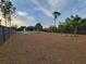 Expansive backyard featuring a putting green, palm trees, and modern fencing, perfect for outdoor activities at 6875 Beckwith Ave, North Port, FL 34291