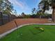 Large backyard featuring putting green, palm trees, and modern privacy fence at 6875 Beckwith Ave, North Port, FL 34291