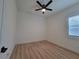 Bedroom featuring laminate flooring, a modern ceiling fan, plantation shutters and white trim at 6875 Beckwith Ave, North Port, FL 34291