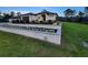 Lush green lawn and a garden in front of this home, accented by a modern privacy fence at 6875 Beckwith Ave, North Port, FL 34291