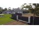 Beautiful exterior view of the home showcasing its expansive yard, fence, screened lanai and modern design at 6875 Beckwith Ave, North Port, FL 34291