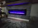 Electric fireplace with colorful lighting and stacked stone surround at 6875 Beckwith Ave, North Port, FL 34291