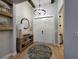 Foyer with decorative shelving, accent wall, chandelier, and light wood-look floors at 6875 Beckwith Ave, North Port, FL 34291