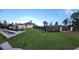 Beautiful front yard with lush green lawn and flower bed, complemented by modern privacy fence at 6875 Beckwith Ave, North Port, FL 34291