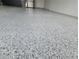 Spacious garage featuring a sleek, epoxy-coated floor that is visually appealing and easy to maintain at 6875 Beckwith Ave, North Port, FL 34291