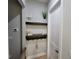 Hallway decor featuring dark wood floating shelves and neutral wall paint at 6875 Beckwith Ave, North Port, FL 34291