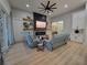 Open living room features a stone fireplace, wood shelves, and recessed lighting at 6875 Beckwith Ave, North Port, FL 34291