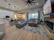 Spacious living room featuring an open floor plan, fireplace, and modern furnishings at 6875 Beckwith Ave, North Port, FL 34291