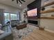 Comfortable living room features a modern fireplace, mounted television, and plush seating at 6875 Beckwith Ave, North Port, FL 34291