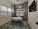 Office space with custom built-ins, plantation shutters, light walls and starfish rug at 6875 Beckwith Ave, North Port, FL 34291