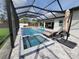 Luxurious screened pool area with a hot tub, comfortable lounge chairs, and a spacious patio for entertaining at 6875 Beckwith Ave, North Port, FL 34291