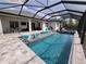 Lanai pool area featuring a private pool, sun loungers, dining table, and an outdoor seating area at 6875 Beckwith Ave, North Port, FL 34291
