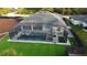 Aerial view of screened pool with lounge chairs and table perfect for entertaining, surrounded by a modern privacy fence at 6875 Beckwith Ave, North Port, FL 34291