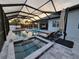 Screened-in pool and spa with lounge chairs, perfect for relaxing and enjoying the outdoors at 6875 Beckwith Ave, North Port, FL 34291