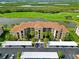 Stunning condo building featuring a tile roof, lush landscaping, and convenient parking at 7019 River Hammock Dr # 306, Bradenton, FL 34212