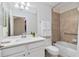 Well-lit bathroom with a shower-tub combo, neutral tile, and ample vanity space at 7019 River Hammock Dr # 306, Bradenton, FL 34212