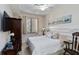 Comfortable bedroom featuring natural light, modern ceiling fan, and stylish decor at 7019 River Hammock Dr # 306, Bradenton, FL 34212